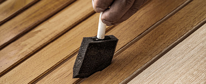 Hand brushing sealer on teak furniture